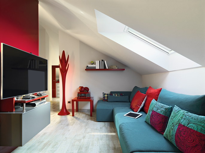 blue fabric sofa and television in the modern living room in the mansard